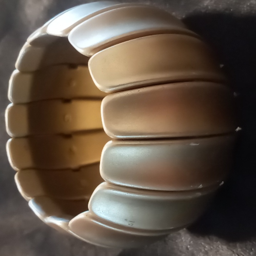 Gold tone wide expandable bracelet.